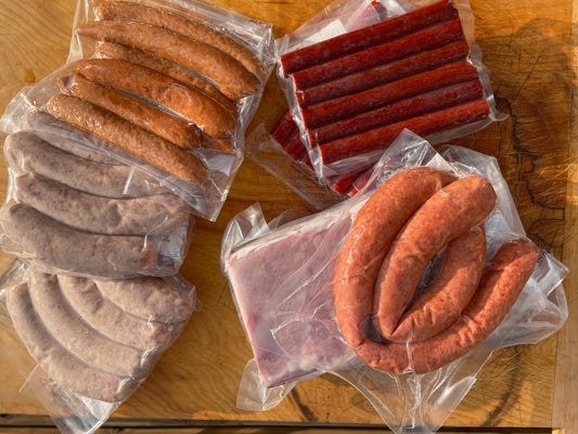 Beer Fed Hogs Sampler including 1 Smoked Coil Sausage, 1 4-Pack Pepperjack Brats, 1 4-Pack Fresh Brats, 1 8-Pack All-Pork Hot Dogs, 1 Country Style Ribs, 1 Pork Strips OR Snack Sticks